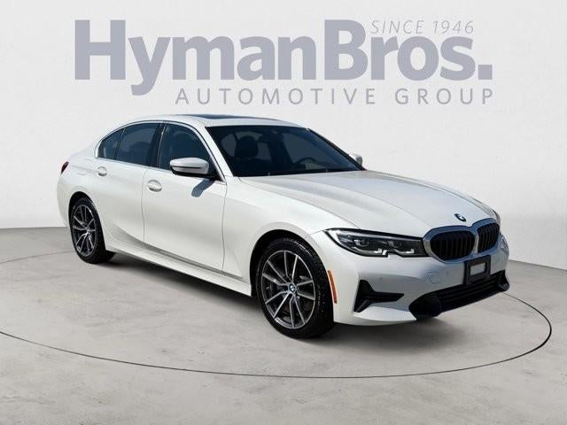2021 BMW 330i Sedan North America in Mineral White Metallic — front three-quarter view