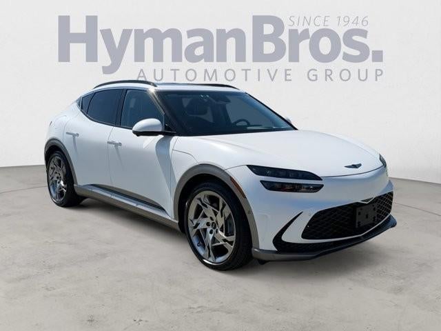 2023 Genesis GV60 Performance AWD in Matterhorn White Matte — front three-quarter view