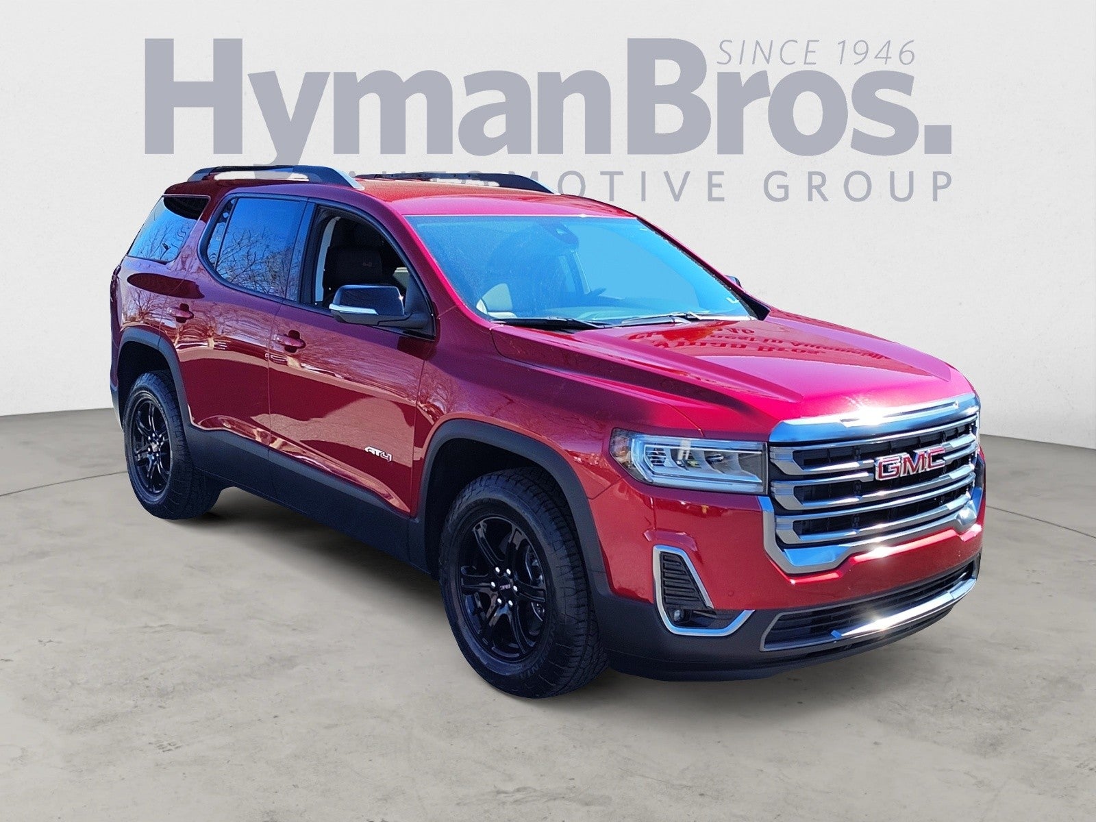 2023 GMC Acadia AT4 AWD in Volcanic Red Tintcoat — front three-quarter view