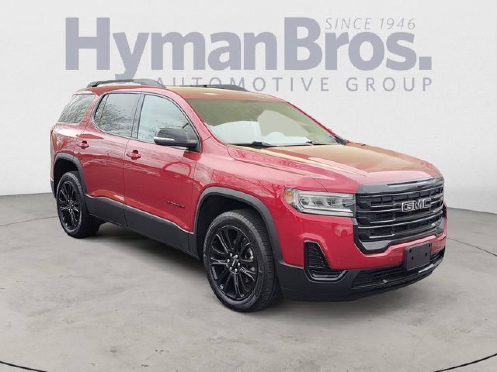 2023 GMC Acadia SLE AWD | Elevation Edition in Volcanic Red Tintcoat — front three-quarter view